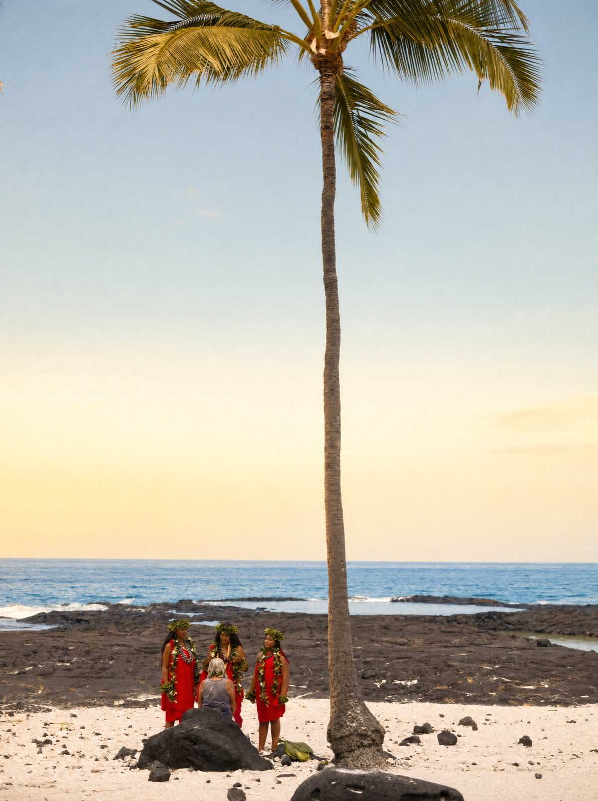 Three generations of Kāhealani's family on the black lava shore