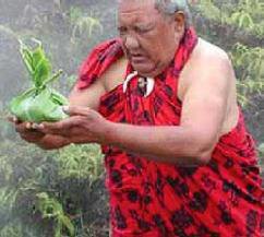 Papa K. Kepilino in ceremony, holding a ti-leaf offering